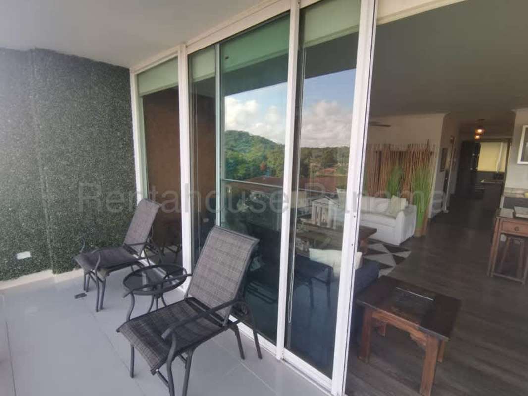 Covered balcony overlooking gardens and trees at PH Garden Hills Albrook Panama