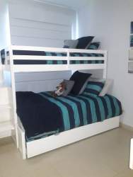 Modern beachfront dining room with glass table and chandelier at Balboa 1 Bijao Resort Panama