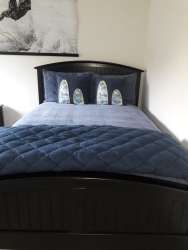 Cozy contemporary bedroom with navy blue bedding oceanfront condo Bijao Balboa 1 Panama