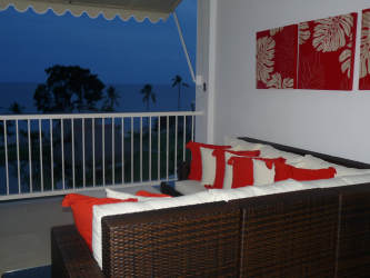 Balcony lounge area with sofas red pillows ocean view Balboa 1 Bijao Resort Panama
