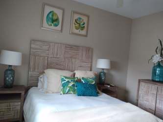 Contemporary bedroom with turquoise accents and wooden furnishings in Bijao Panama