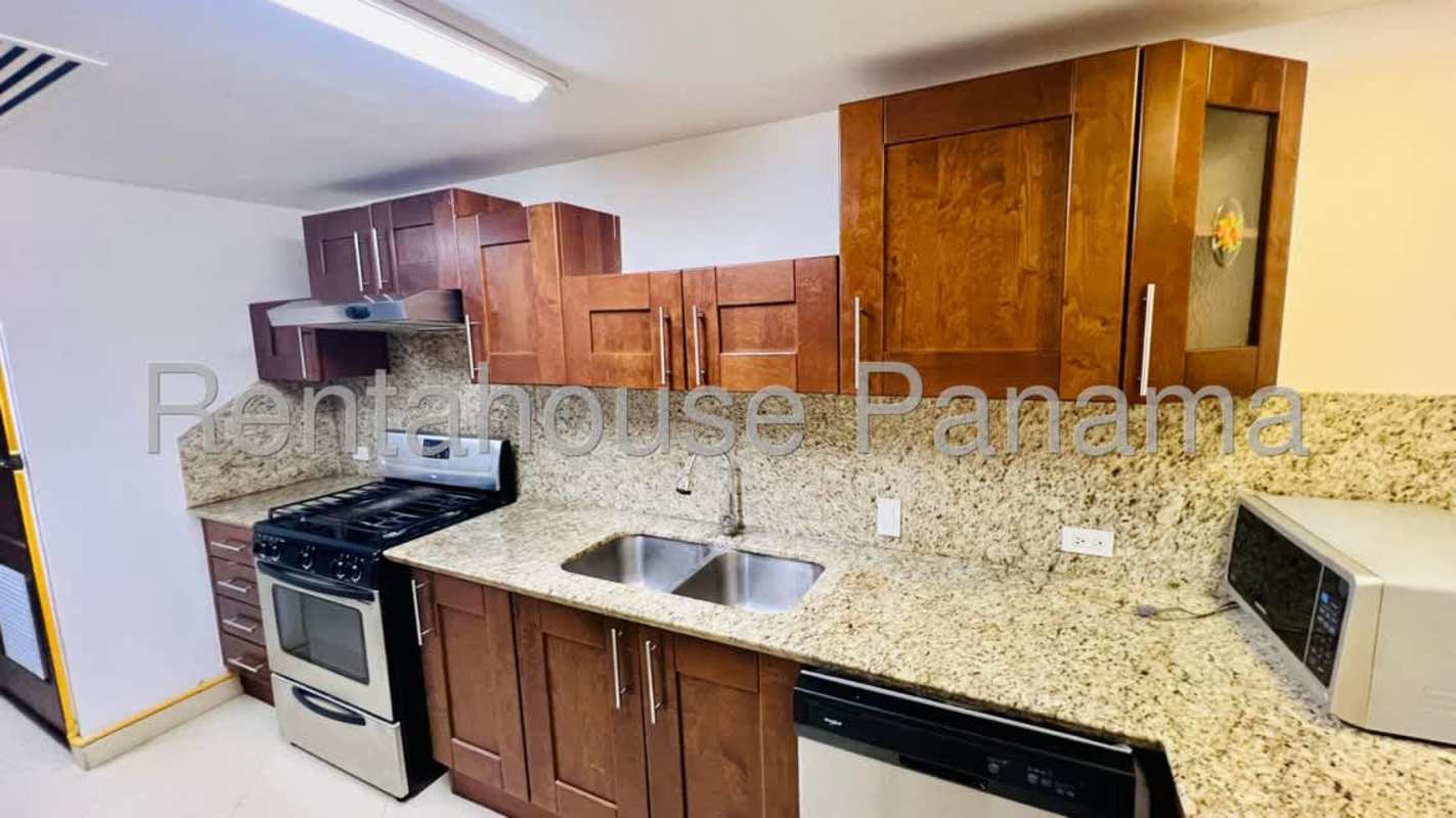 Contemporary kitchen with granite counters, wood cabinets Embassy Club Clayton Panama