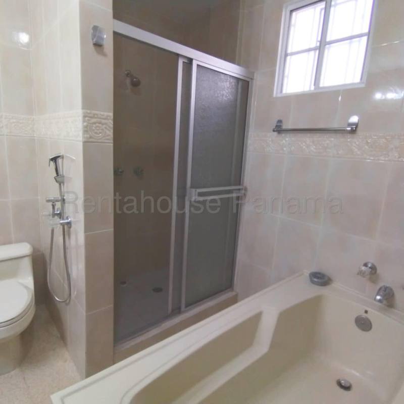 Traditional bathroom with bathtub, beige tiles, and decorative accents Costa del Este Panama house rental