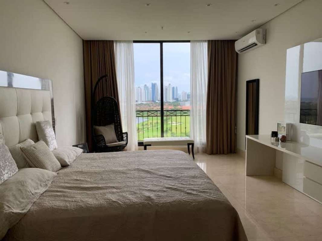 Bedroom with skyline view via large window in Santa Maria Panama luxury apartment