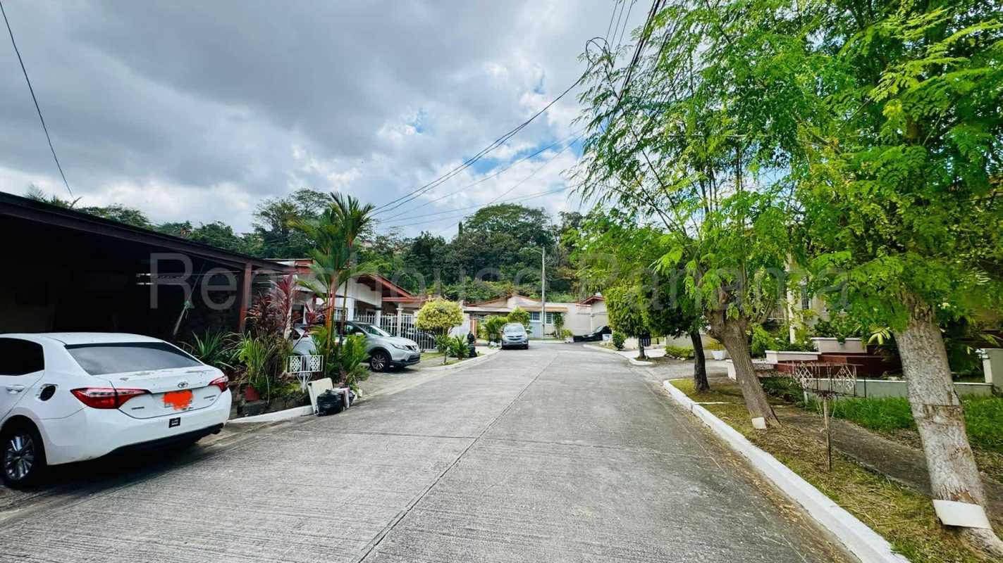 Front street view of single-family home with driveway and gardens in Quintas de Monticello II Brisas del Golf Panama City