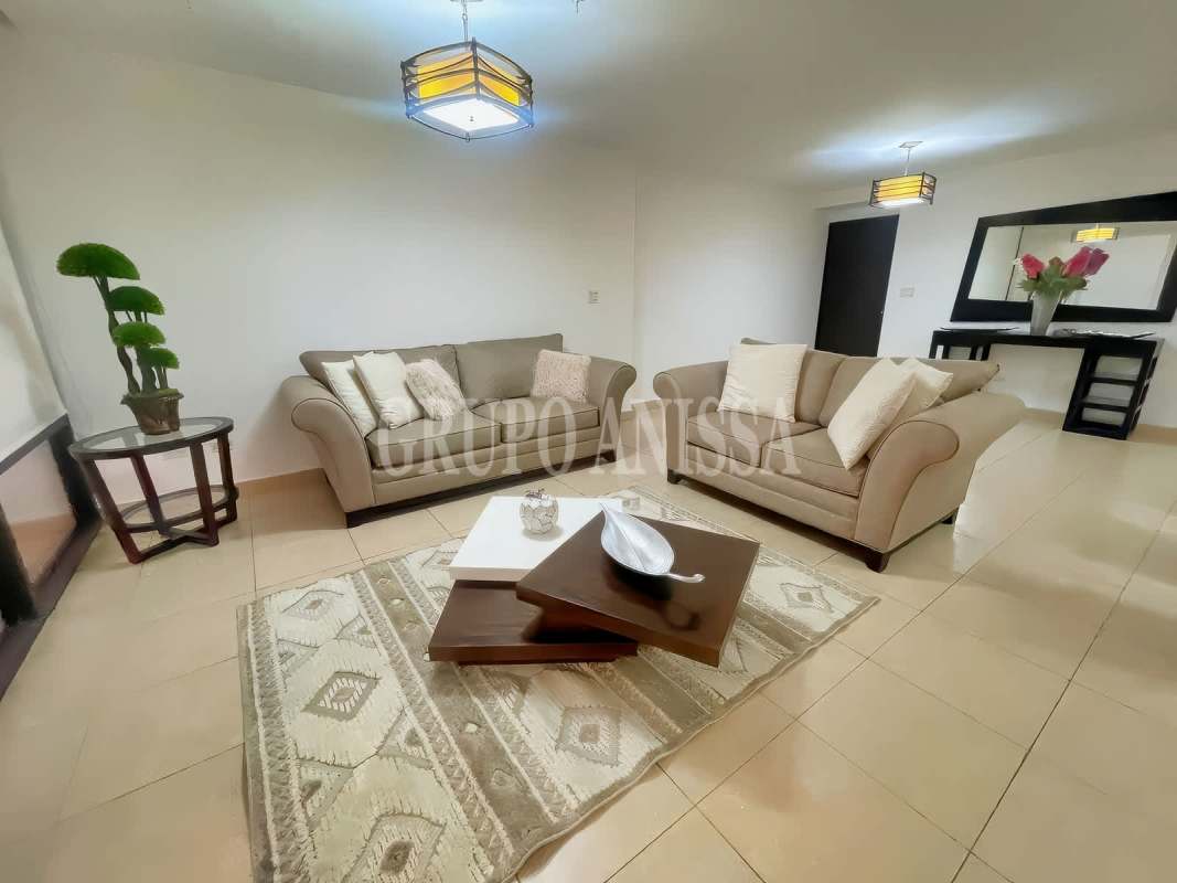 Furnished living room with beige sofas and modern decor at PH Parque del Mar Costa del Este