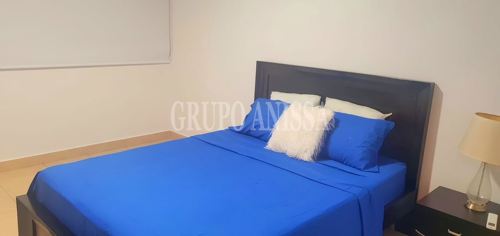 Bedroom with queen size bed and blue accents in PH Parque del Mar Costa del Este