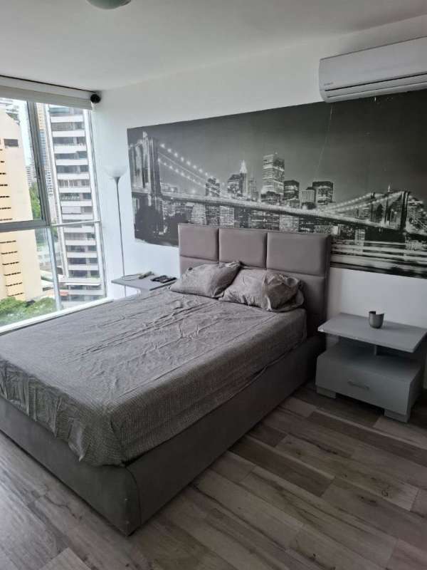 Bedroom with city skyline mural, large window with urban view in Pacific Sky Tower Panama