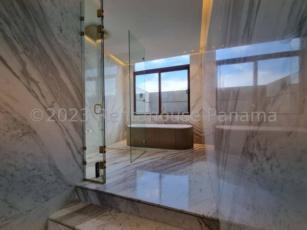 Luxury gated entrance with palm trees, circular driveway, landscaping Ocean Reef Panama