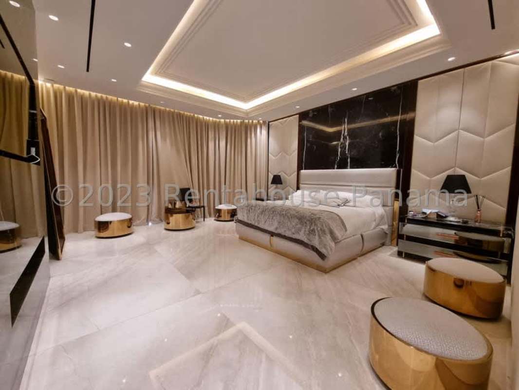 Walk-in closet with custom shelving, mirrored panels, marble floors Ocean Reef Panama