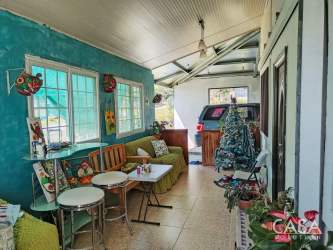 Kitchen view with wood cabinets, floral curtains and appliances Boquete Panama
