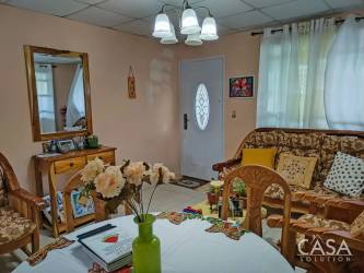 Compact bedroom with wooden bunk bed, colorful bedding, wardrobe Volcancito Boquete property