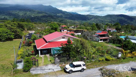 Aerial image of fenced house with red roof and garden at Volcancito Boquete Panama