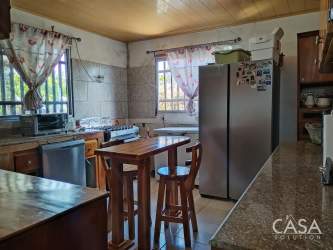 Traditional kitchen with island, granite countertop, appliances and window views Volcancito Boquete house