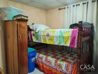 Traditional style living room with oval window front door, patterned sofa, dining area Volcancito Boquete Panama