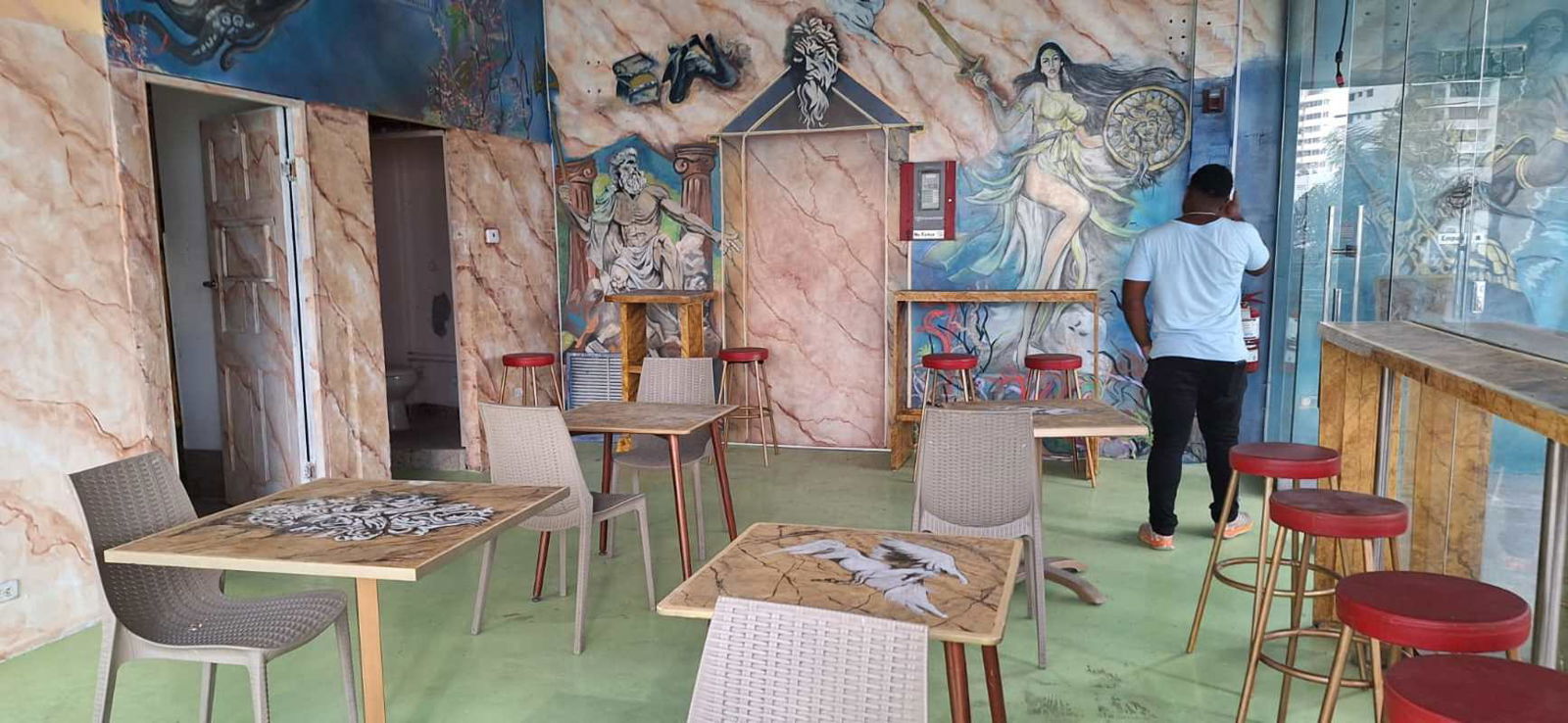 Modern indoor dining space with natural light, wood accents, glass facade at PH BICSA Panama