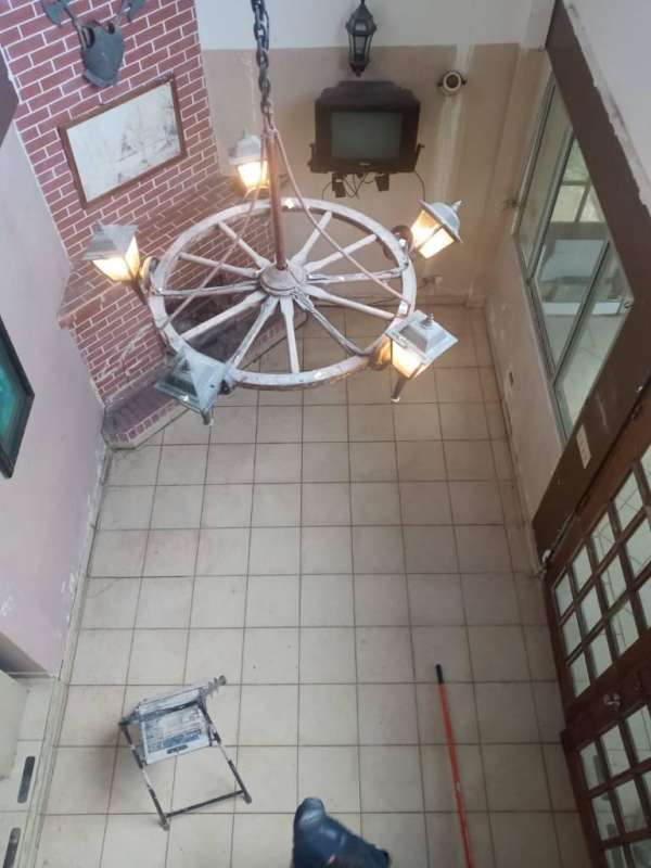 Simple bedroom with metal bed tile floor louver windows Cerro Azul Panama house