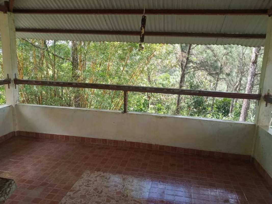 Covered terrace with tiled floor metal railing mountain forest views Cerro Azul Panama