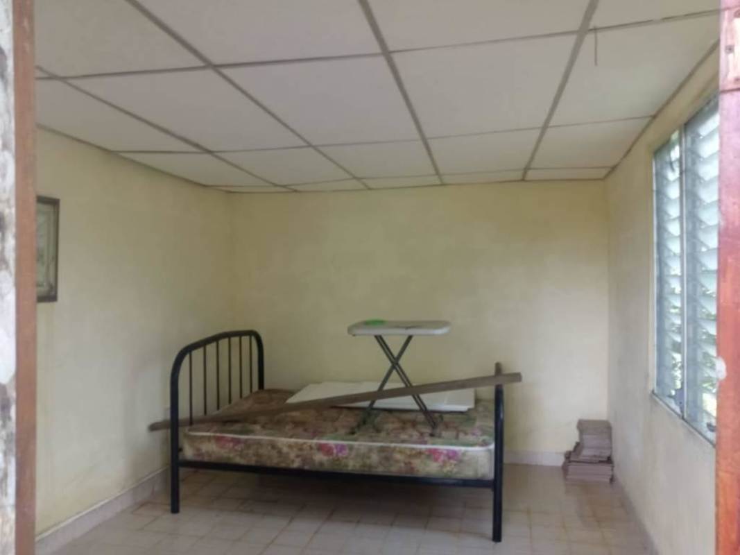 Exterior of rustic house with covered porch garden view Cerro Azul gated community Panama