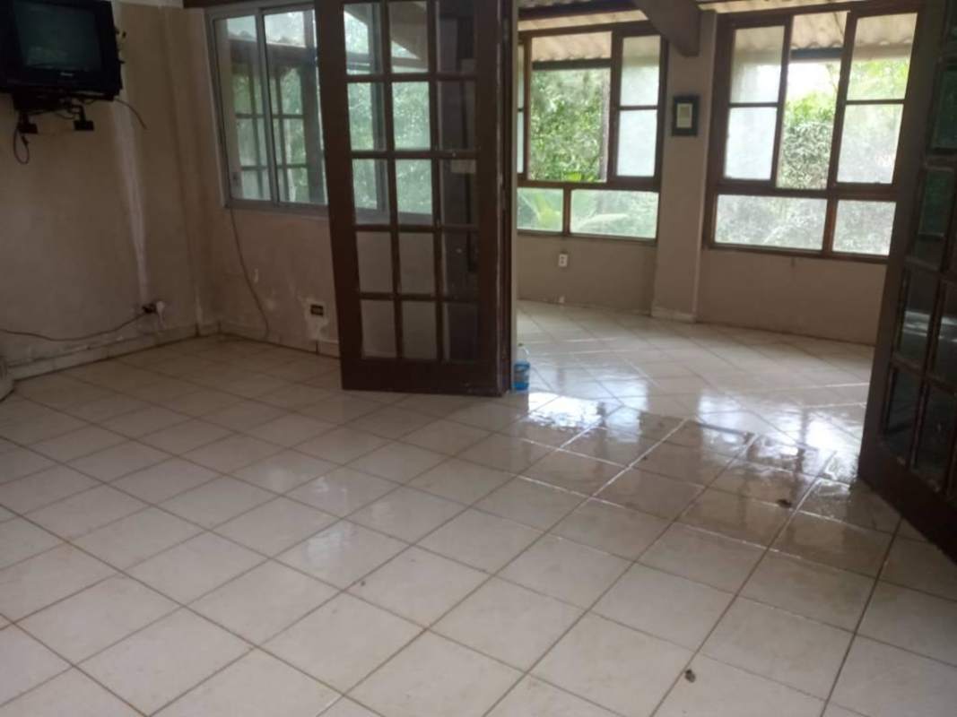Bright living room with tiled floor glass doors sunroom Cerro Azul mountain house Panama