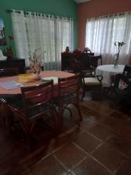 Dining area with colorful walls, large windows, and natural light in country house Panama