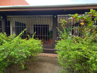 Exterior house view with security bars, covered porch, garden at San José countryside home