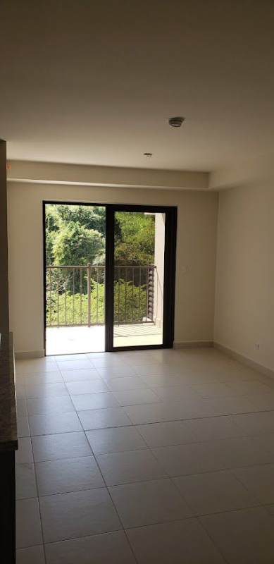 Bright living room with sliding glass doors to balcony Embassy Village Clayton Panama