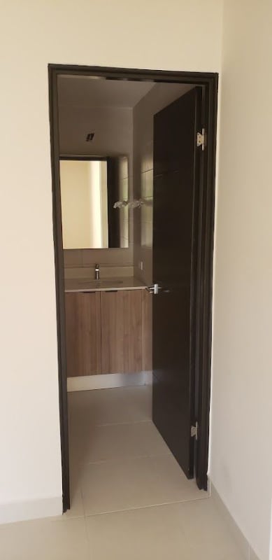 Bathroom with large mirror and wood vanity in Embassy Village Albrook Clayton Panama