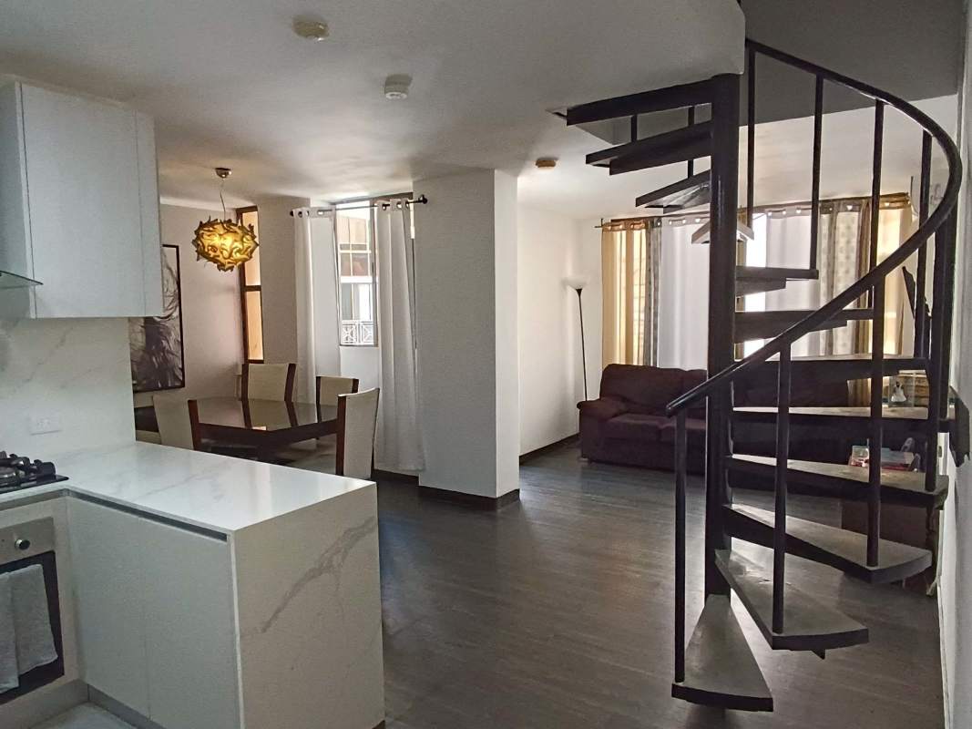 Contemporary open-plan living dining kitchen with spiral staircase in PH Torre del Rey Hato Pintado Panama