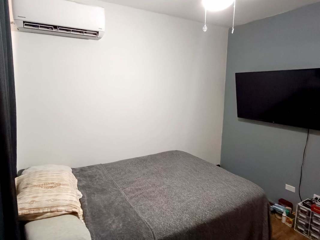 Minimalist bedroom with AC ceiling fan large window at PH Torre del Rey Hato Pintado Panama