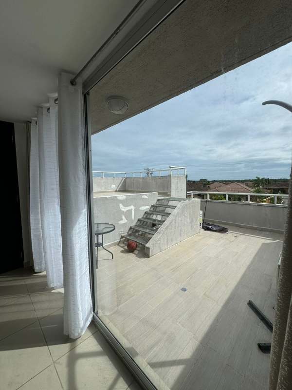 Outdoor backyard patio with pergola, string lights and garden in Costa Sur Village Panama City