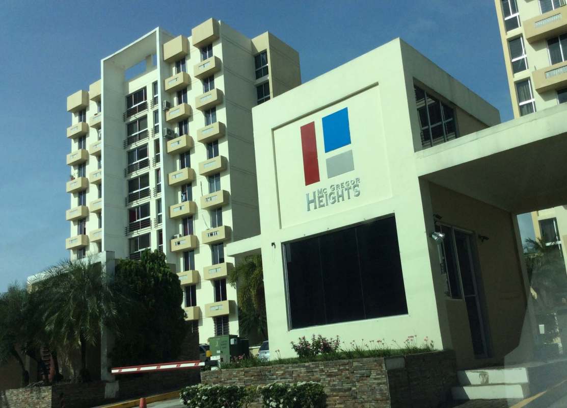 Modern apartment complex courtyard with playground swings, slides and garden at PH McGregor Heights Panama