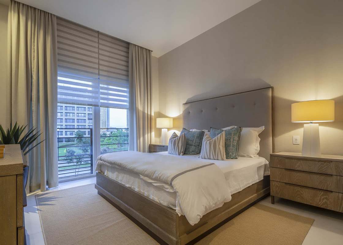 Open-plan luxurious dining and living area with chandelier and large windows at The Woods Santa María Panama