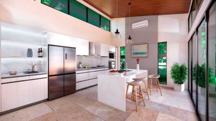 Spacious bright kitchen with island bar stools natural light floor to ceiling windows Costa Esmeralda Panama