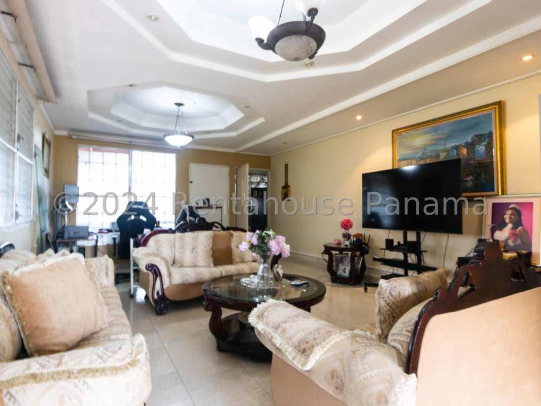 Contemporary kitchen with granite countertops, cabinets, and large window Panama house