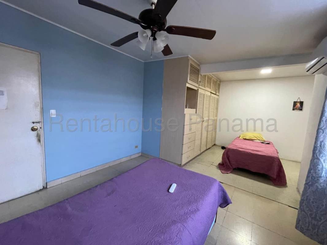 Traditional dining and living area with tile floors, chandelier, enclosed patio view in Betania Panama City house