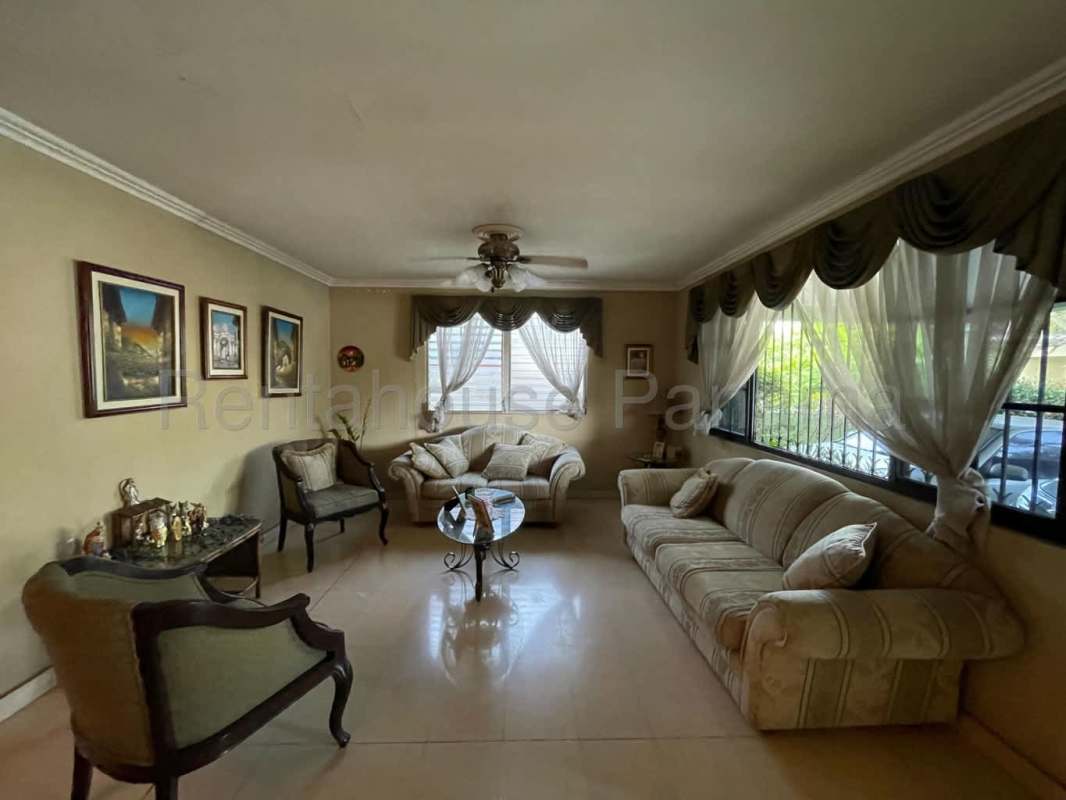 Traditional style kitchen with cabinets, granite countertop and large window Betania house Panama