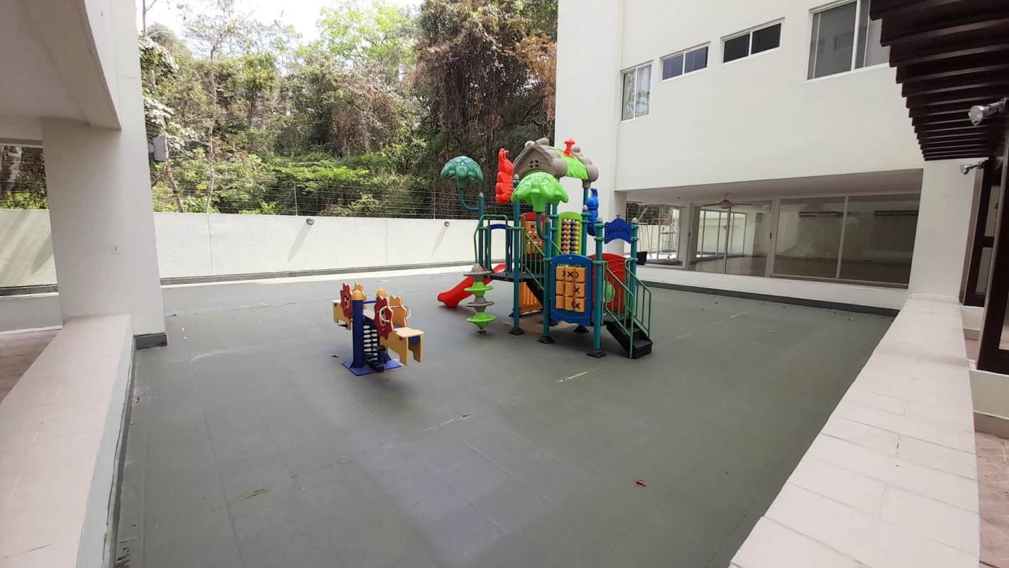 Safe children's play area with slides and equipment at PH Met View Towers
