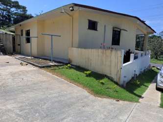 Outdoor sloped lawn with trees, fence and concrete steps Puerto Pilón Colon Panama house