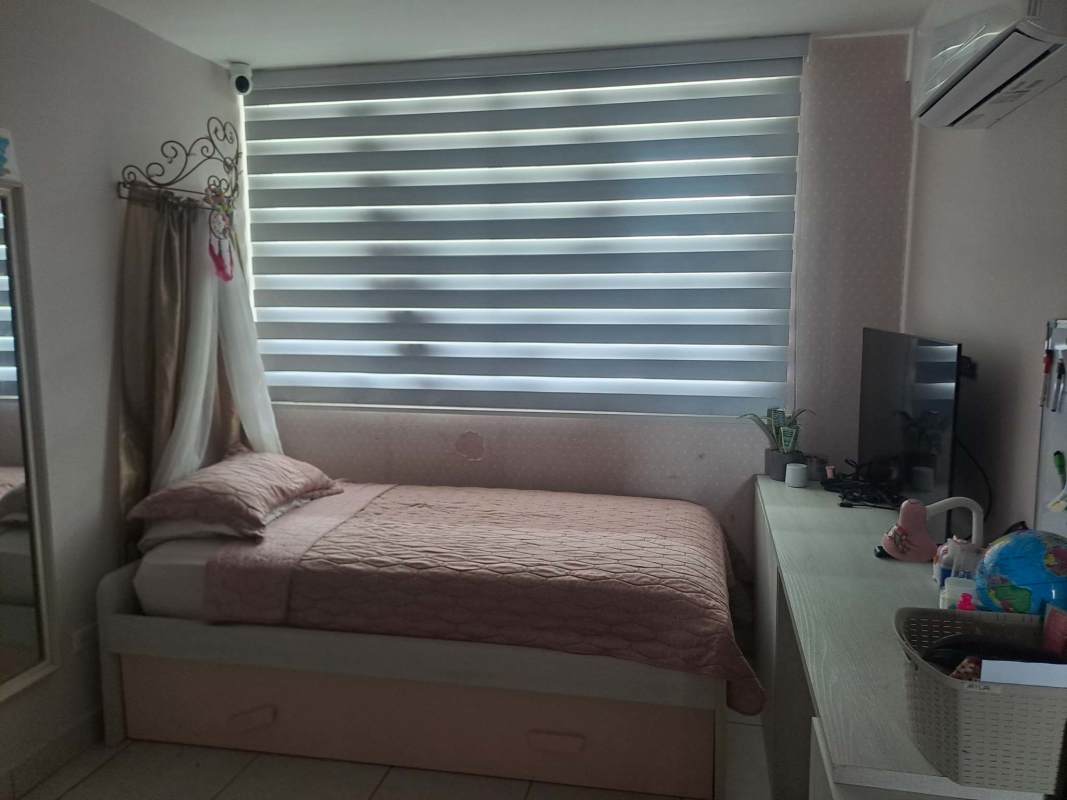 Bright bedroom with pink themed decor, large window, work desk and AC at PH El Mare 600 Edison Park Panama City