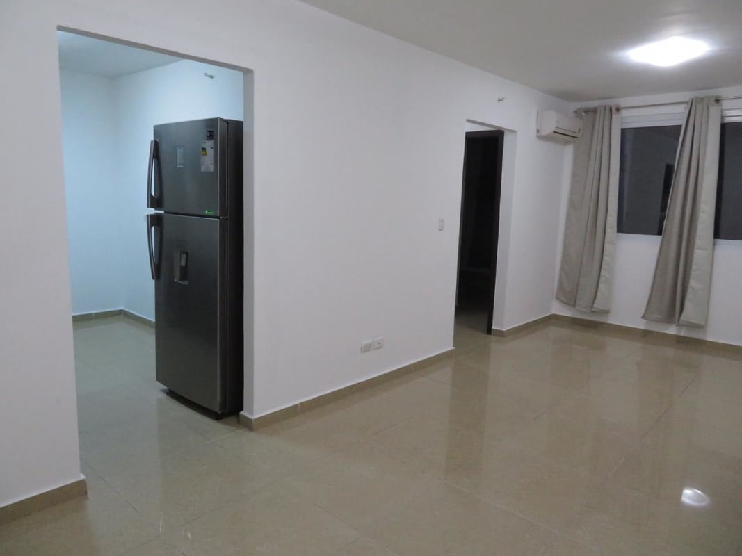 Apartment kitchen with granite countertops, fridge, stove, tile backsplash at PH URBIS Tower Panama City.