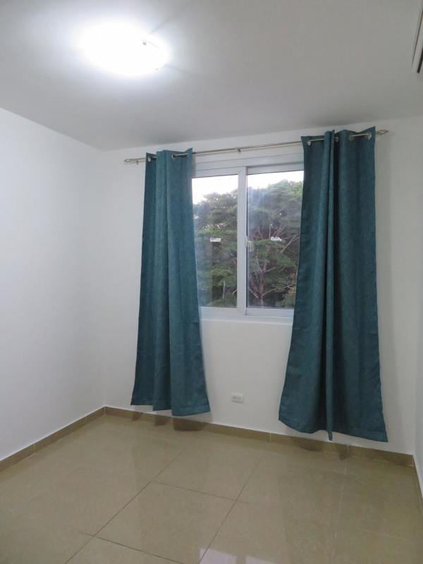 Bedroom in PH URBIS Tower with closet, tiled floor, large window and AC Panama City.