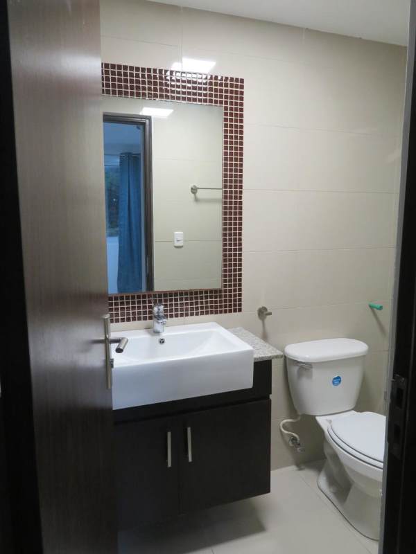 Bathroom featuring glass-enclosed shower, granite counter, modern sink in PH URBIS Tower Panama.