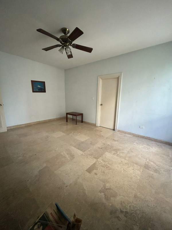 Traditional furnished bedroom with seating and ceiling fan PH Regent Panama