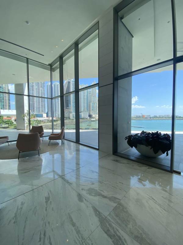 Spacious contemporary lobby featuring marble surfaces, city skyline and waterfront vistas in PH Sea Point Punta Paitilla Panama