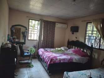 Bedroom double beds AC window curtains rural home Ocú Panama