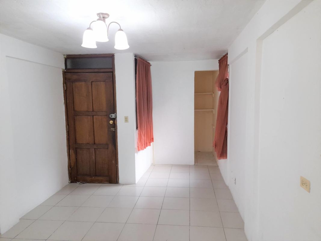 Compact tiled kitchen with natural light, white cabinetry in Villa Cáceres Panama City