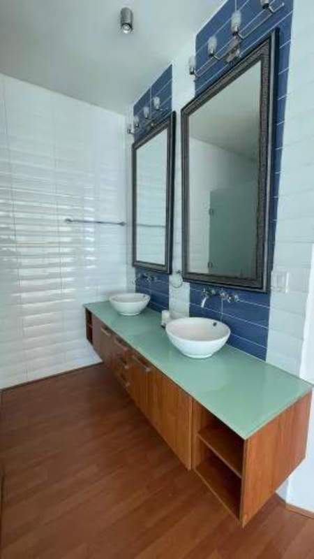 Luxury bathroom with double vanity vessel sinks and blue tiles PH Loft 41 Panama City