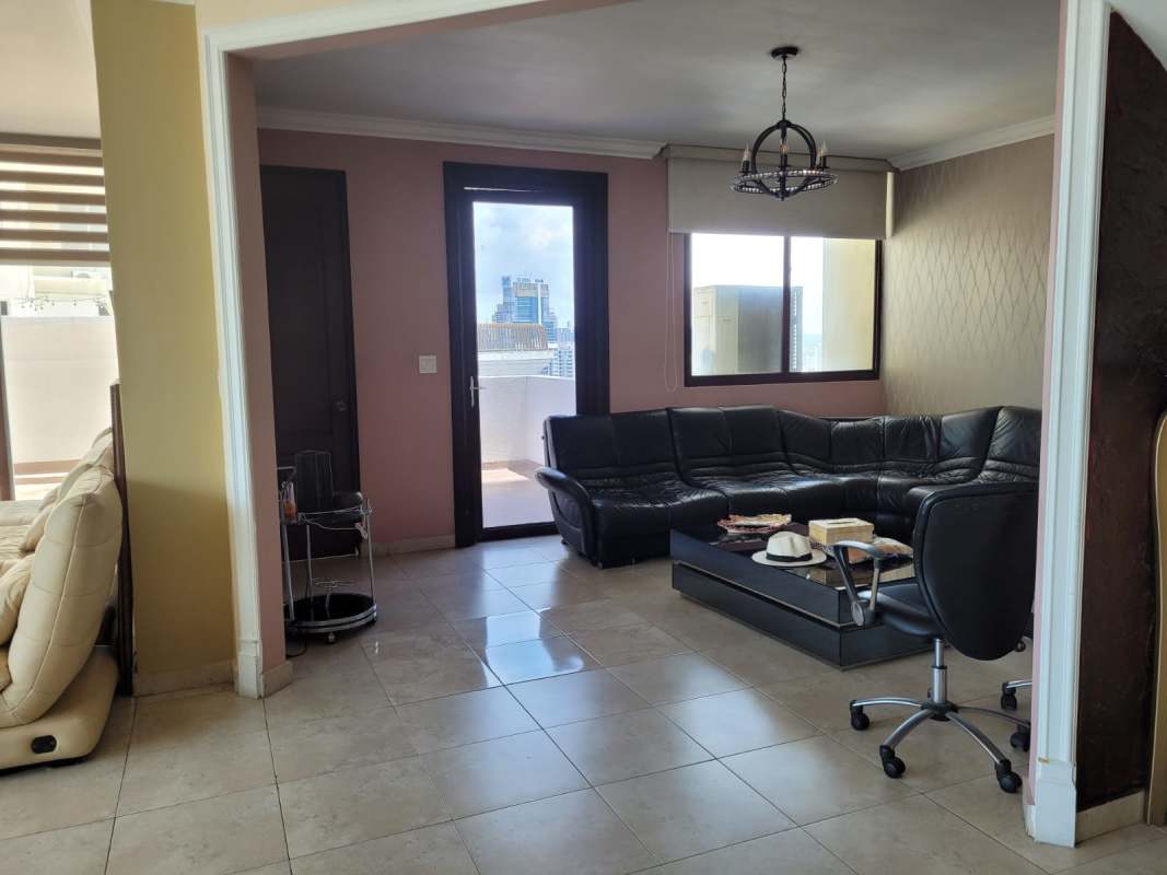 Large living and dining area with panoramic windows overlooking ocean and skyline in Mystic Point Punta Pacifica penthouse