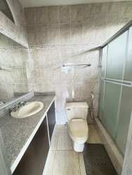 Modern kitchen with stainless steel appliances, granite counters, and tile floors in Residencial Howard Panama